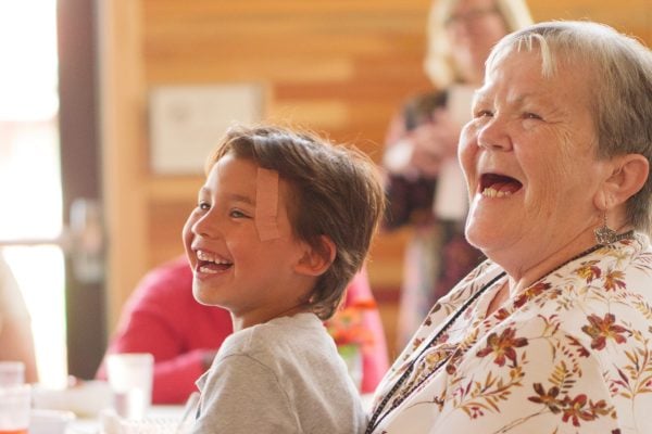 Older woman and young boy laughing