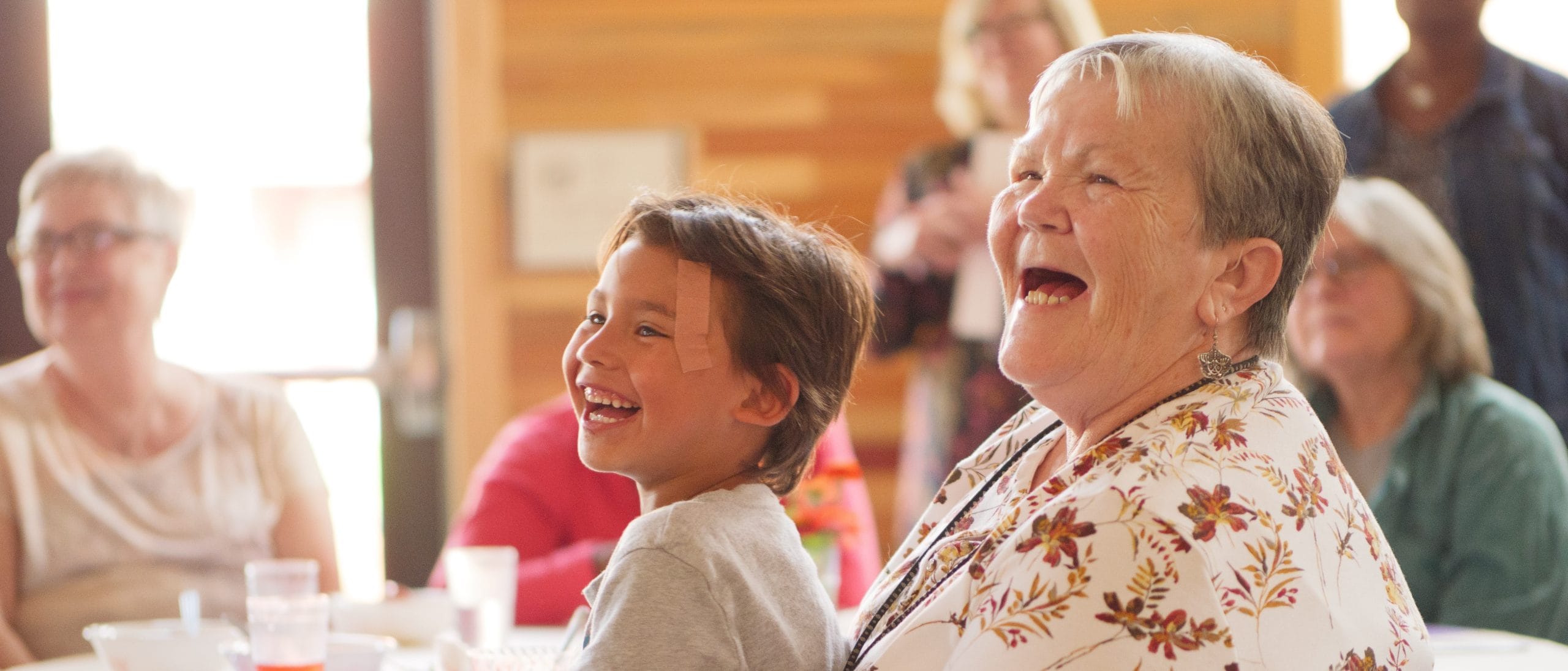 Older woman and young boy laughing