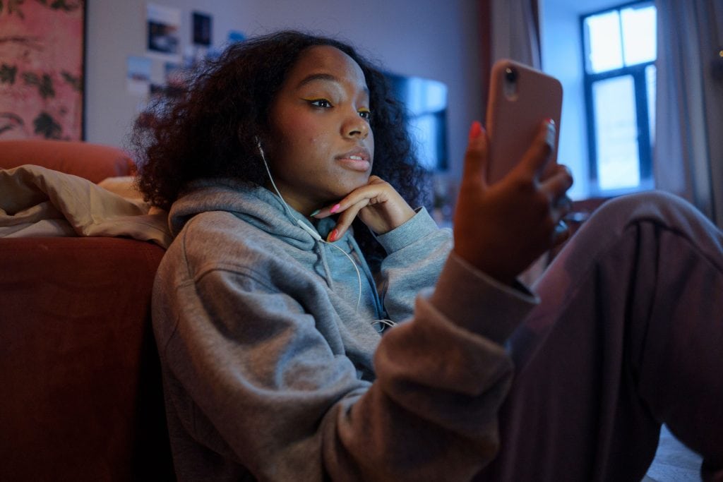 A young person looking at their phone